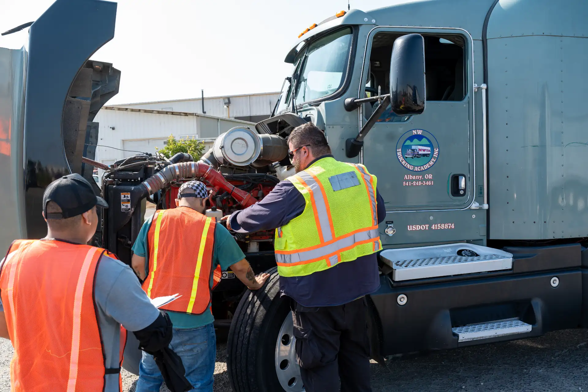 NW Trucking Academy students doing a pre-trip inspection with an instructor