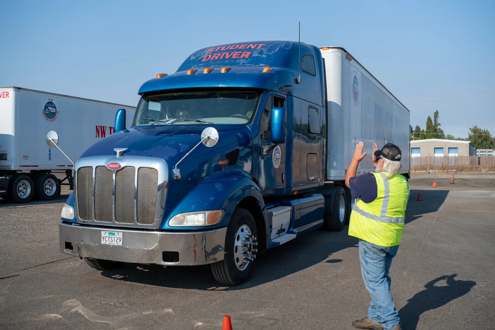 Instructor guiding a student backing a training truck