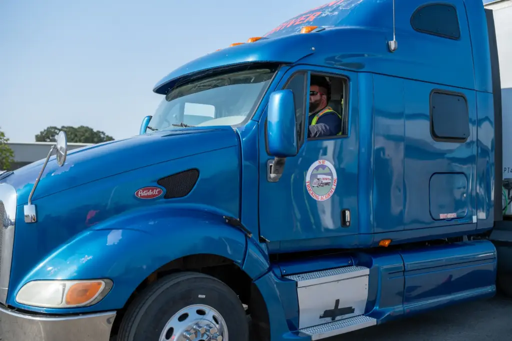 Driver at the wheel of an NW Trucking Academy training truck
